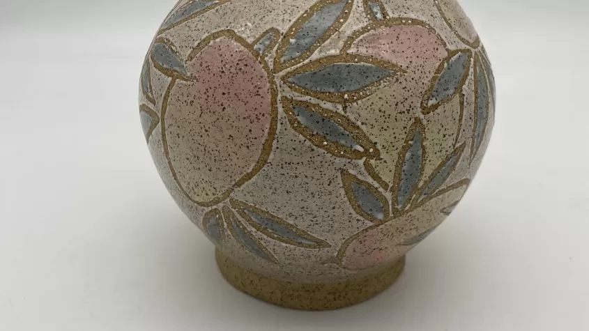image of a small pottery vase with mangoes painted on it