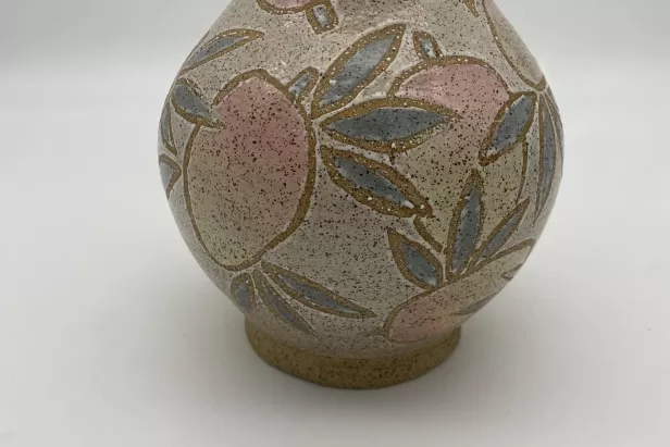 image of a small pottery vase with mangoes painted on it
